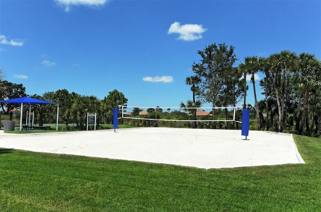 surrounding community with volleyball court and a lawn