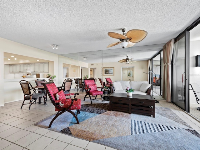 tiled living room with ceiling fan and a textured ceiling