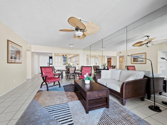 living room with light tile patterned floors, a textured ceiling, and ceiling fan