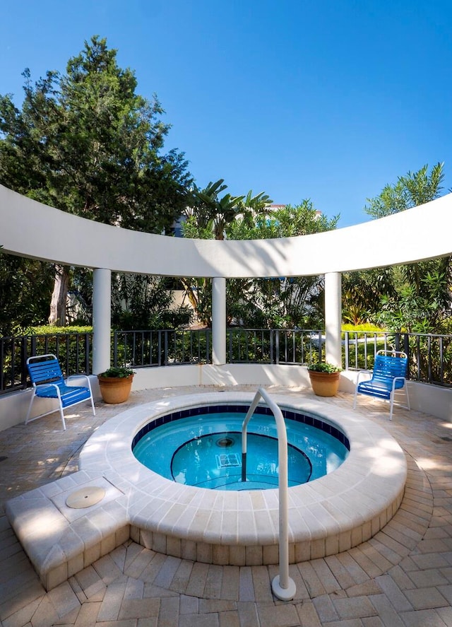 view of swimming pool with a community hot tub and a patio