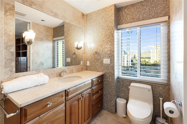 bathroom featuring plenty of natural light, tile walls, and vanity