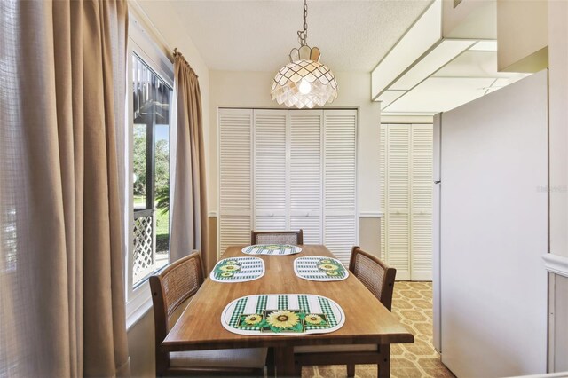 dining area with a textured ceiling