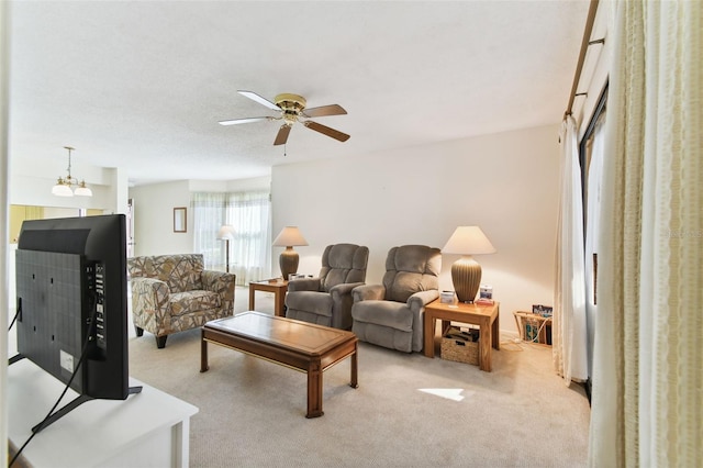 carpeted living room featuring ceiling fan