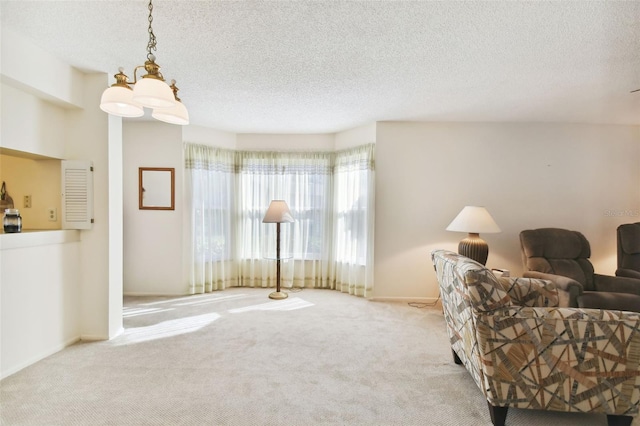 living area with light colored carpet and a textured ceiling