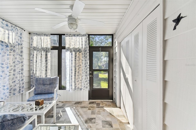 sunroom / solarium with ceiling fan and wooden ceiling