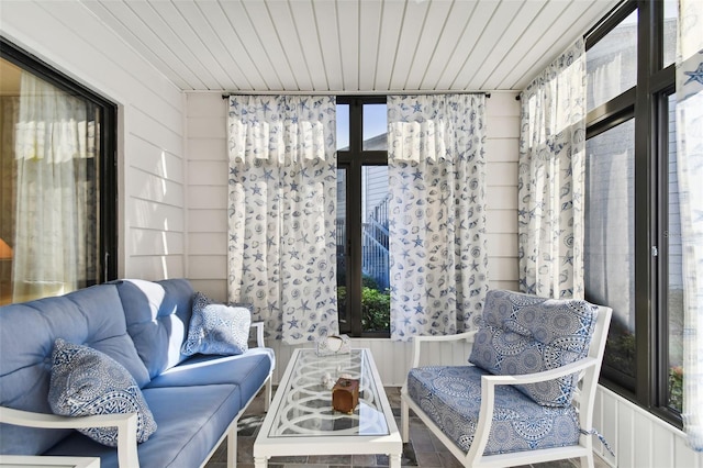 sitting room with wood ceiling and wooden walls