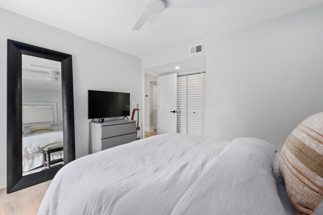 bedroom with ceiling fan, light wood-type flooring, and a closet