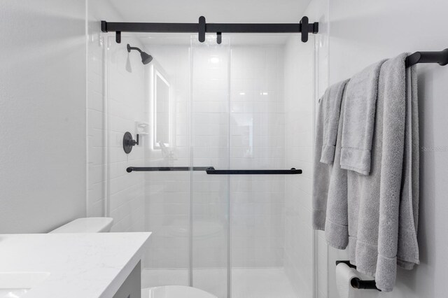 bathroom with vanity, toilet, and an enclosed shower