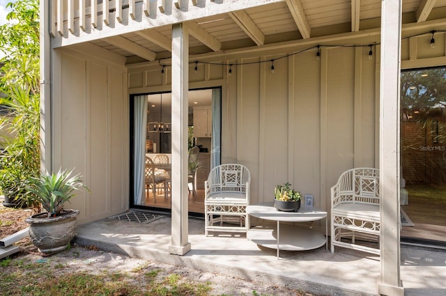 view of exterior entry featuring a balcony and a patio