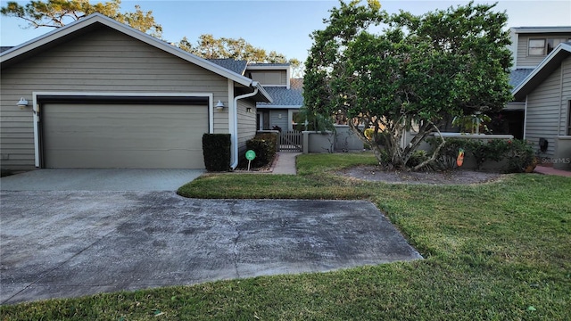 view of front of house with a garage and a front lawn