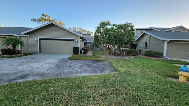 view of front of home with a front yard and a garage