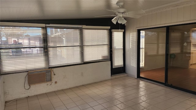 unfurnished sunroom featuring a wall mounted AC, ceiling fan, and lofted ceiling