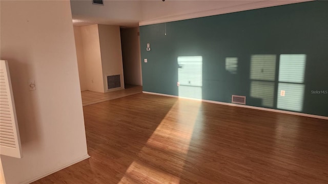 unfurnished room with hardwood / wood-style flooring