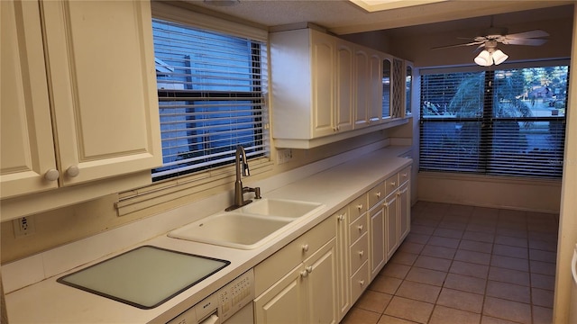 kitchen with light tile patterned flooring, ceiling fan, and sink