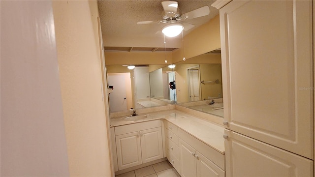 bathroom featuring tile patterned floors, ceiling fan, vanity, and a textured ceiling