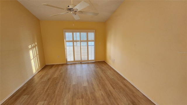 spare room with ceiling fan and light wood-type flooring