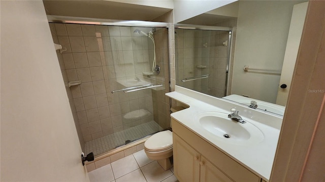 bathroom with tile patterned floors, a shower with door, vanity, and toilet