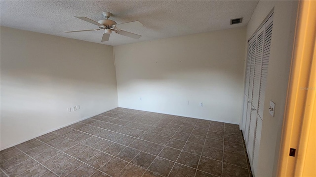 unfurnished bedroom with a textured ceiling, a closet, and ceiling fan