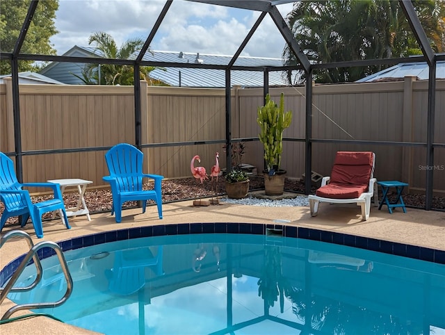 view of pool with a patio and a lanai