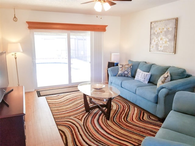 living area featuring ceiling fan and wood finished floors