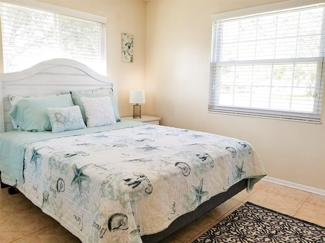 bedroom with tile patterned flooring and baseboards