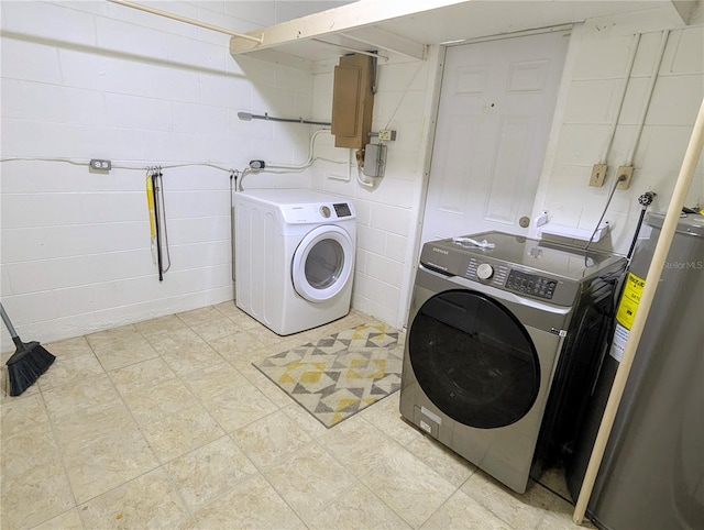 washroom featuring independent washer and dryer, electric panel, and water heater