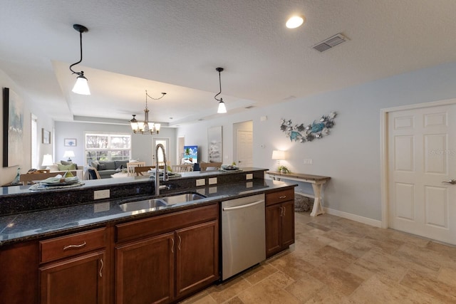 kitchen featuring stainless steel dishwasher, hanging light fixtures, dark stone countertops, and sink