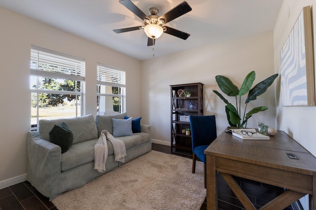 home office with ceiling fan and dark hardwood / wood-style flooring