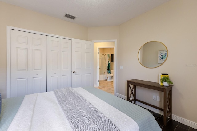 bedroom with a textured ceiling and a closet