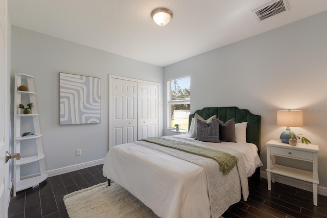 bedroom with dark hardwood / wood-style flooring and a closet