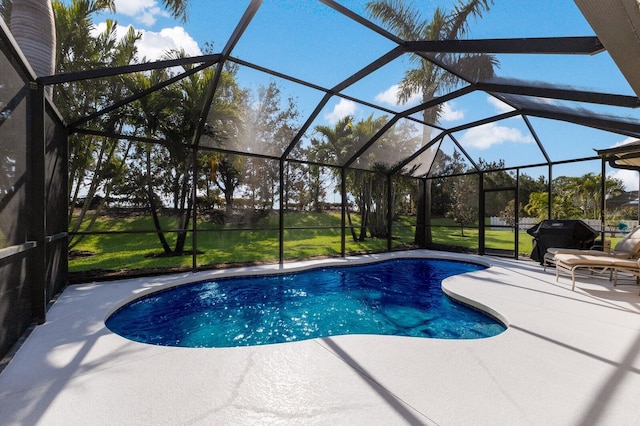 view of swimming pool with a lawn, a patio area, glass enclosure, and grilling area