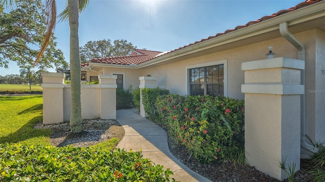 doorway to property featuring a yard