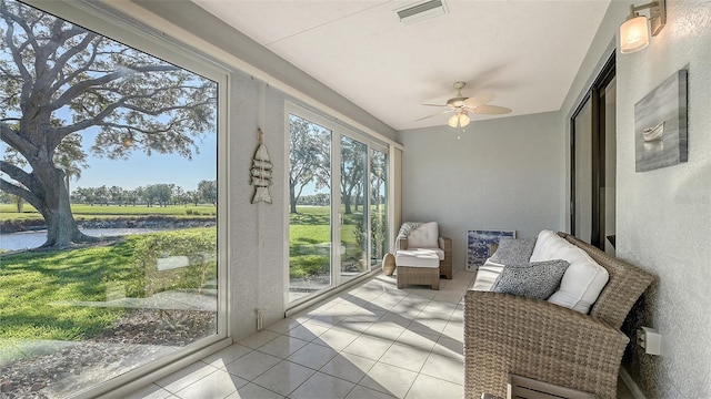 sunroom featuring ceiling fan