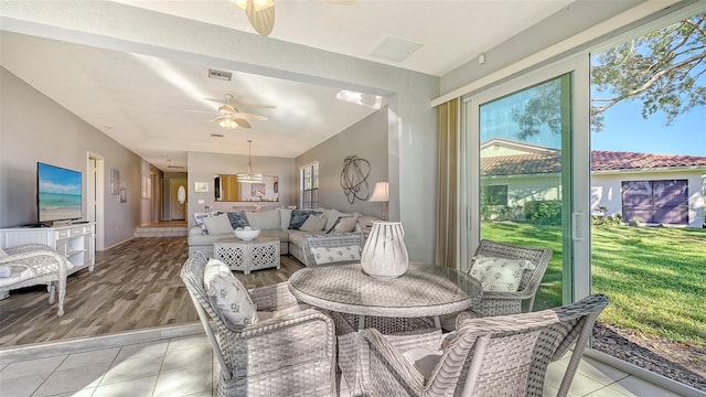 sunroom / solarium featuring ceiling fan