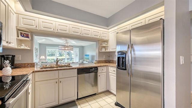 kitchen featuring light stone countertops, appliances with stainless steel finishes, sink, light tile patterned floors, and white cabinets