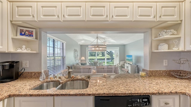 kitchen with light stone countertops, a notable chandelier, dishwasher, and sink