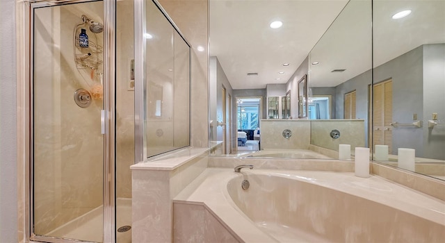 bathroom featuring shower with separate bathtub