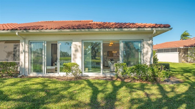 rear view of property with a lawn