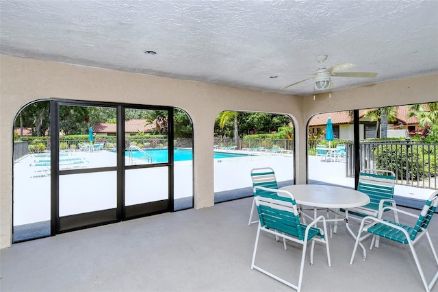 sunroom / solarium with ceiling fan