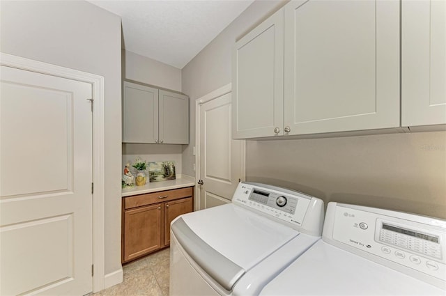 washroom with cabinets, light tile patterned floors, and separate washer and dryer