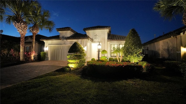 mediterranean / spanish house with a garage