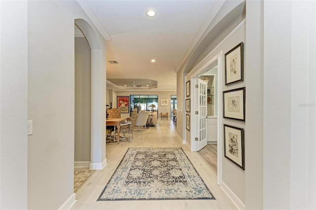 corridor featuring light hardwood / wood-style floors and ornamental molding