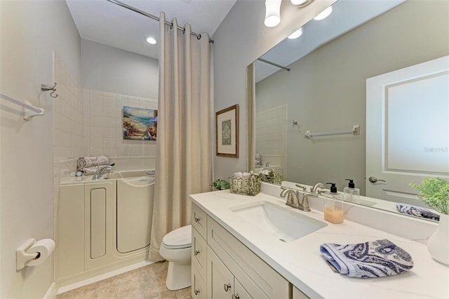 bathroom featuring tile patterned floors, vanity, and toilet