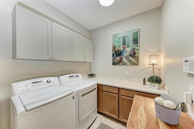 laundry area with cabinets and washing machine and clothes dryer