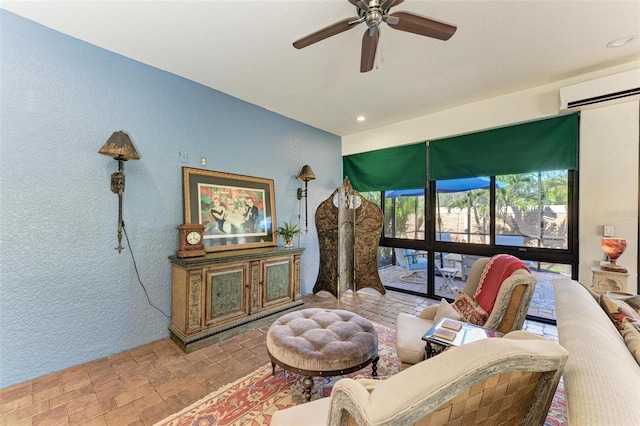 living room with ceiling fan and a wall unit AC