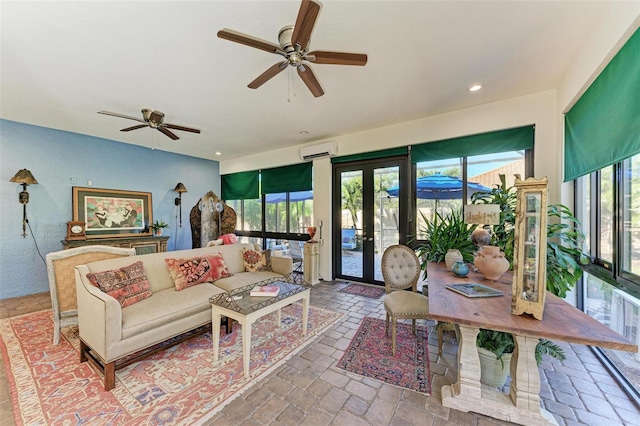 living room featuring a wall mounted air conditioner, french doors, plenty of natural light, and ceiling fan