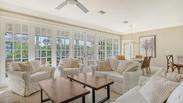 sunroom / solarium with french doors and ceiling fan with notable chandelier