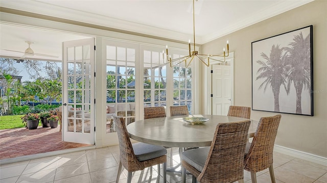 interior space with a wealth of natural light, crown molding, french doors, and a notable chandelier