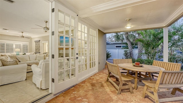 sunroom with ceiling fan, a healthy amount of sunlight, and french doors