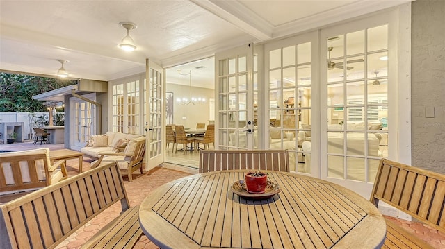 sunroom / solarium with ceiling fan, beam ceiling, and french doors